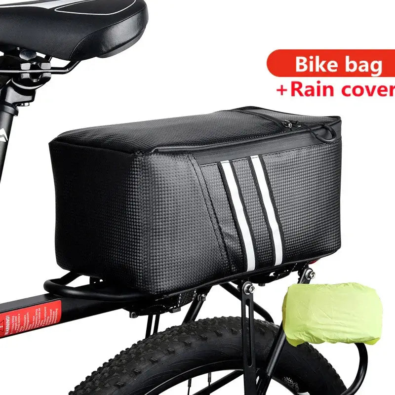 Rear bike rack bag with reflective stripes and rain cover, mounted on bicycle.