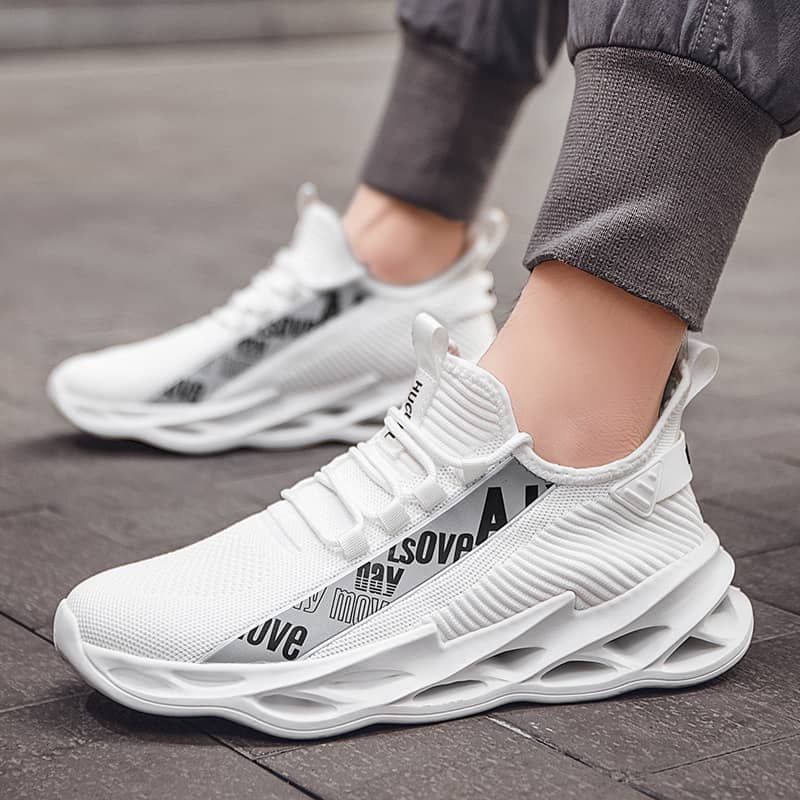 White athletic shoes with text on a wooden floor
