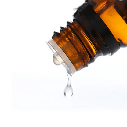 Close-up of an amber glass bottle with a dropper on a white background