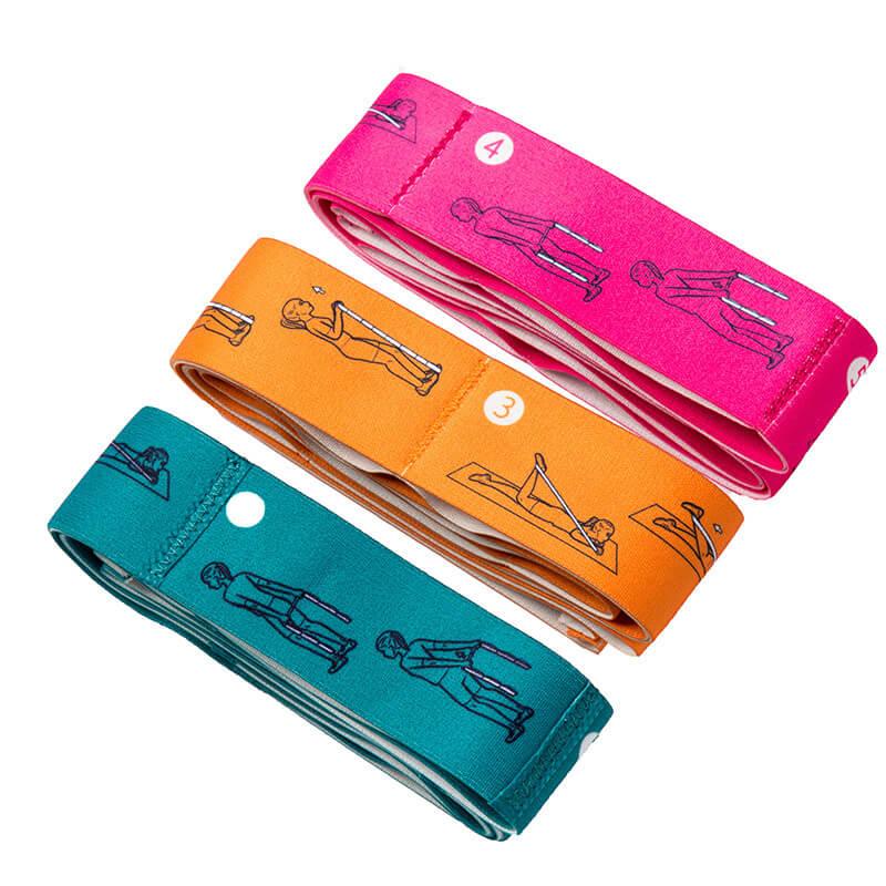 Set of three colorful fabric resistance bands with exercise illustrations for strength training