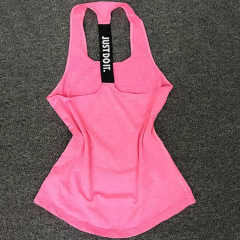 Pink racerback athletic tank top with black 'Just Do It.' strap on grey background