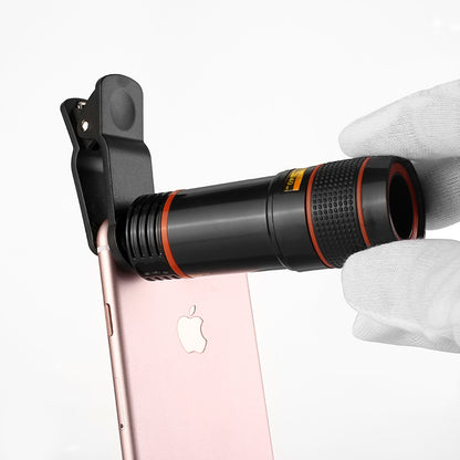 Phone with a telescope attachment held by a gloved hand on a white background