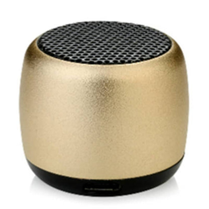 Gold portable speaker with black mesh on a white background