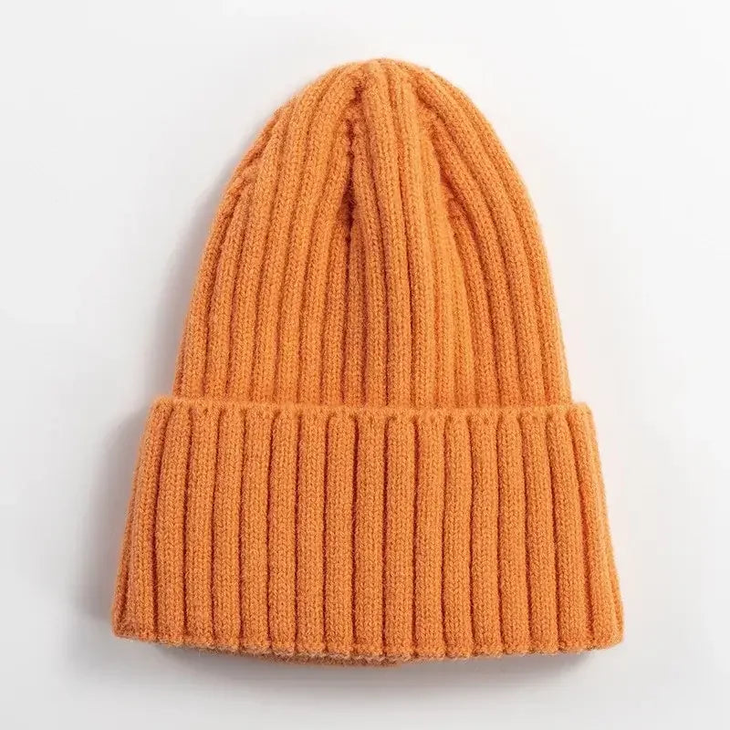 Orange ribbed knit beanie hat, cozy winter outdoor apparel on white background