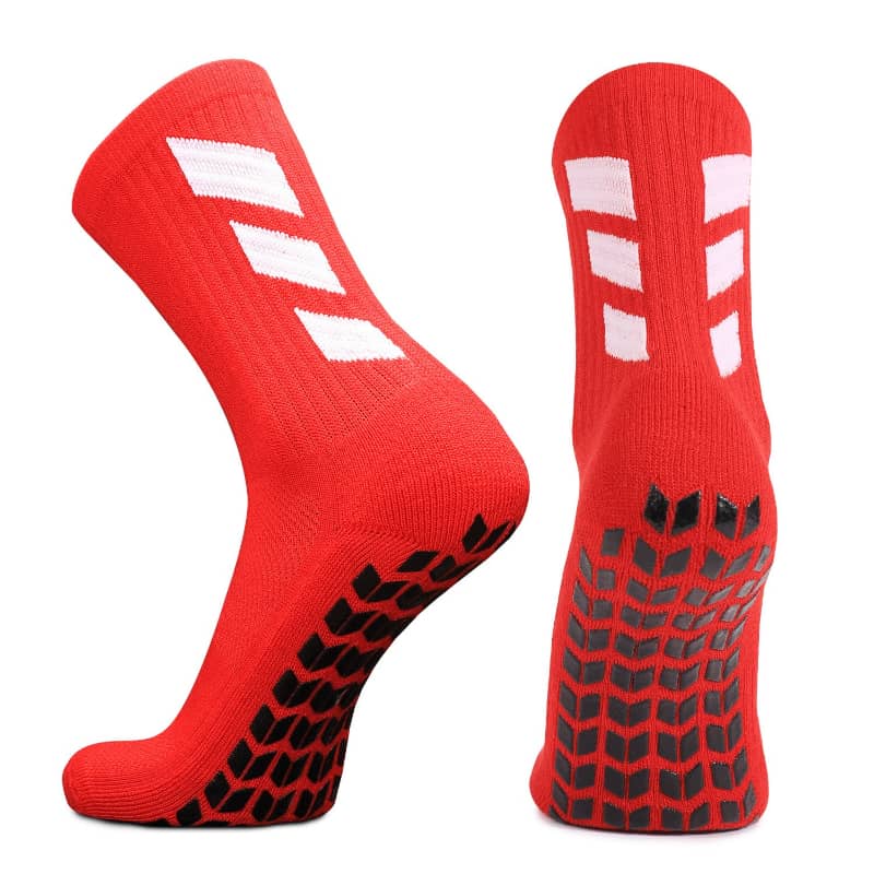 Red socks with white stripes and black textured sole on a white background