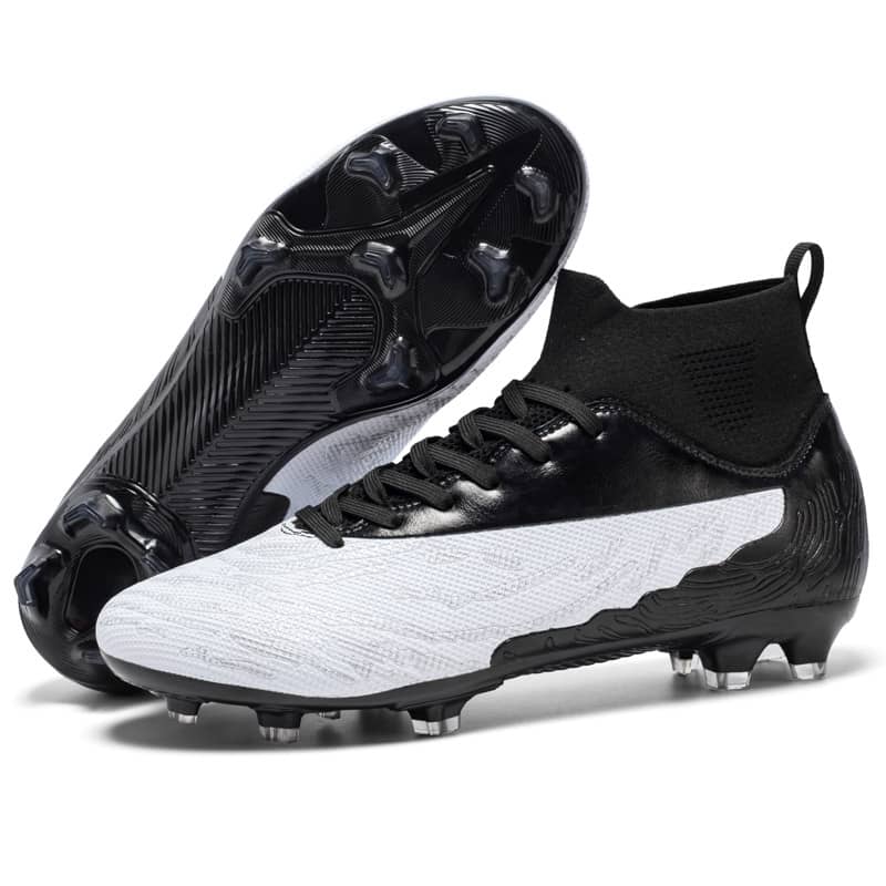 Pair of black and white soccer cleats on a white background