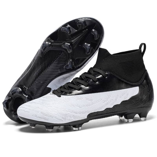 Pair of black and white soccer cleats on a white background