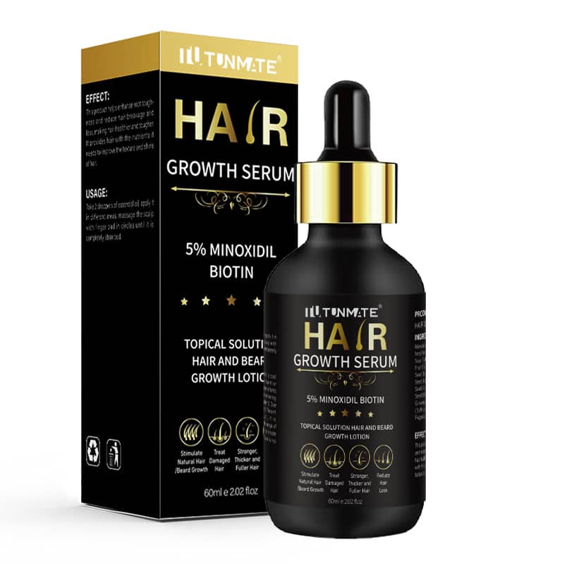 Hair growth serum bottle and packaging with gold accents on a white background