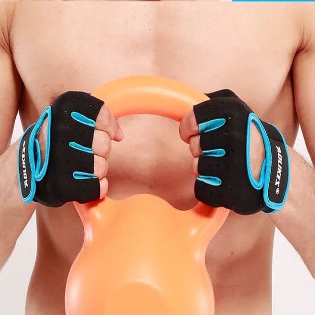 Person wearing black gloves with blue accents holding an orange resistance band.
