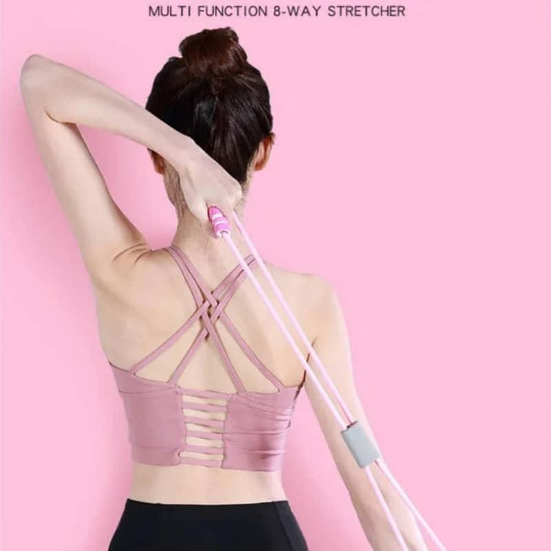 Woman using pink 8-way stretch resistance band for shoulder and upper back exercise