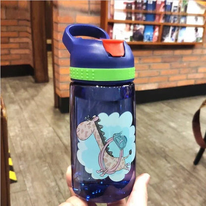 Blue fitness water bottle with green band and giraffe cartoon design, held in hand indoors