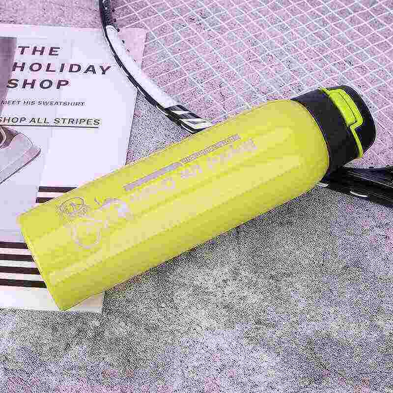 Yellow fitness water bottle and badminton racket on gym floor, hydration gear for workouts