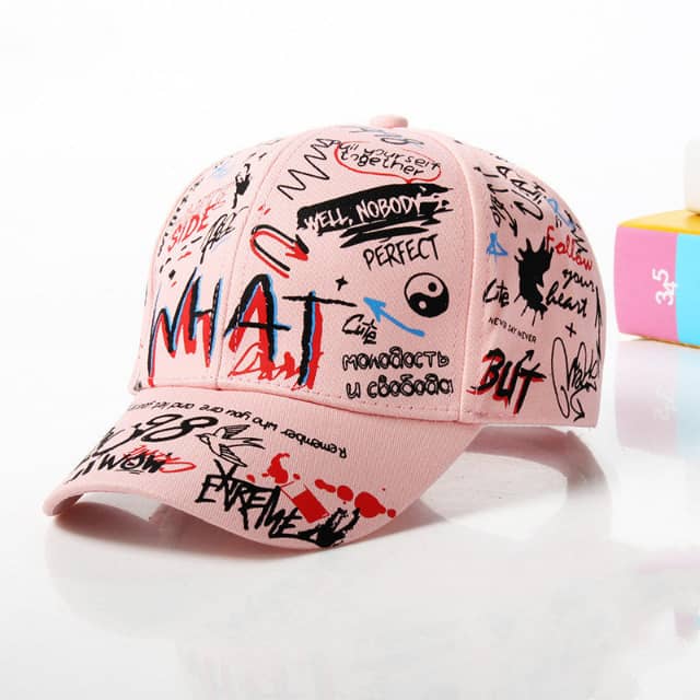 Pink baseball cap with graffiti style writing and abstract designs, streetwear accessory