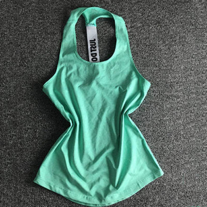 Mint green women's athletic tank top with racerback on gray background