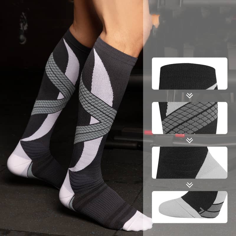 Black and gray compression socks with geometric patterns on a dark background