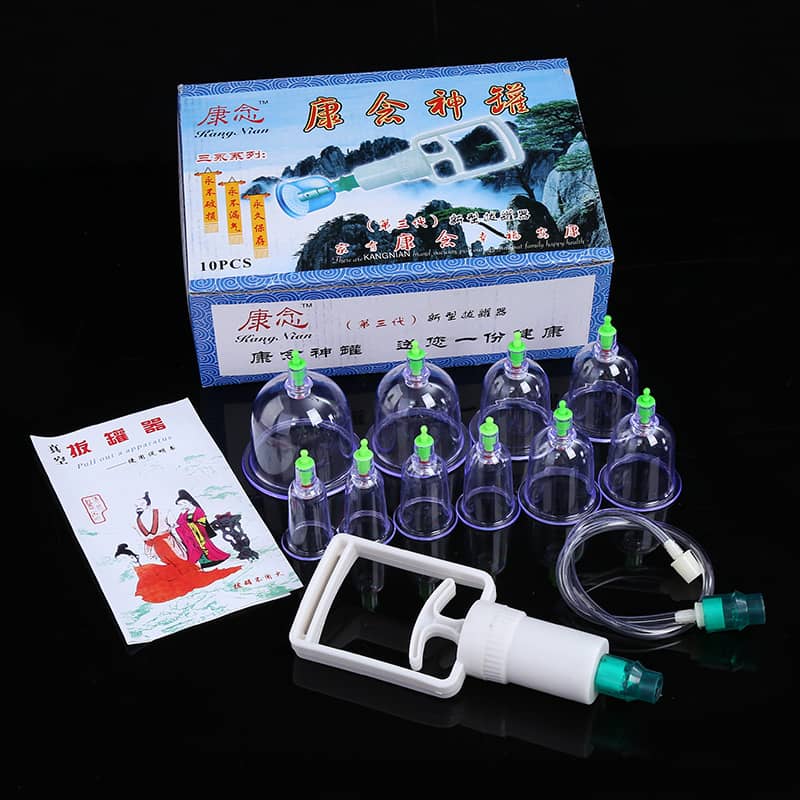 Vacuum cupping therapy set with plastic cups, hand pump, and instruction manual on black background
