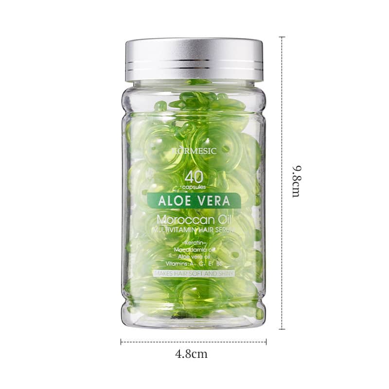Glass jar with green capsules labeled 'Aloe Vera' on a white background
