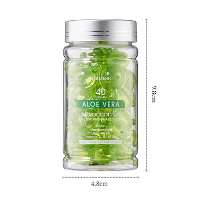Glass jar with green capsules labeled 'Aloe Vera' on a white background