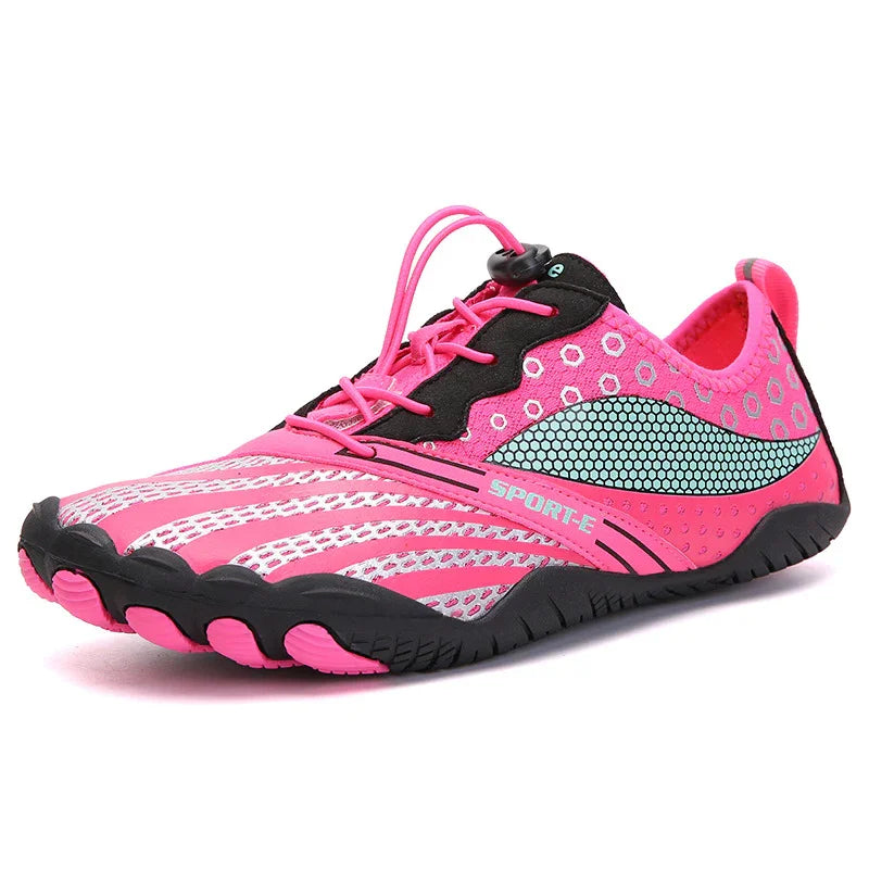 Pink lightweight athletic shoe with black sole, mesh panels, and quick-lace system