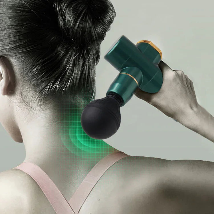 Person using green and black massage gun on upper neck and shoulder for muscle relief