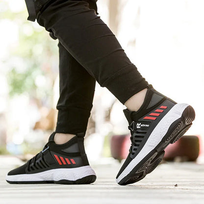Close-up of black and white running shoes with red accents worn by a person in black pants, outdoor fitness setting