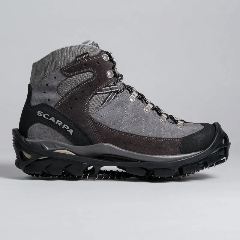 A high-top Scarpa hiking boot in gray suede and mesh with black rubber toe and sole, shown from a side profile on a light gray background.