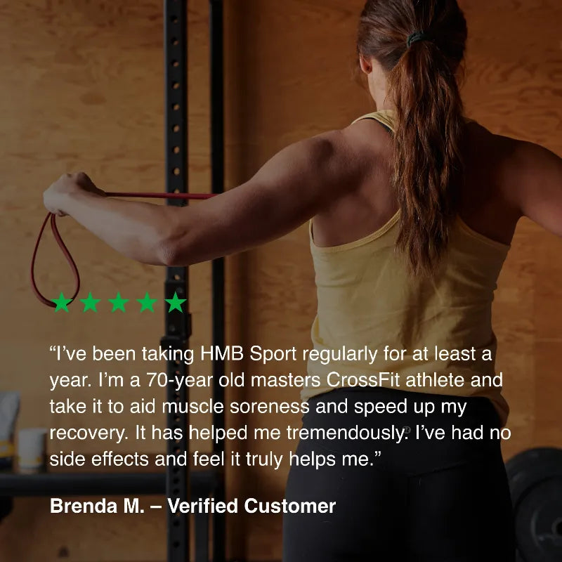 A woman in a gym wearing a yellow tank top and black leggings, stretching a red resistance band. A large testimonial quote by Brenda M.