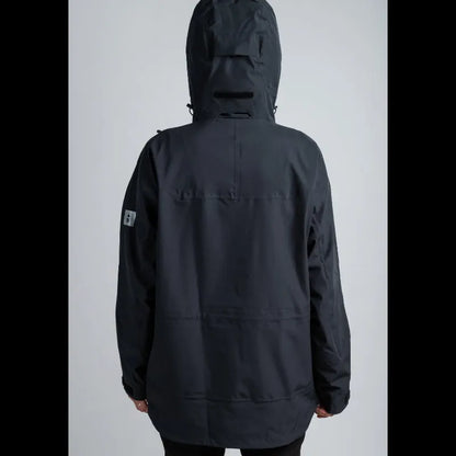 A person shown from the back wearing a dark charcoal black hooded jacket against a light gray studio background.