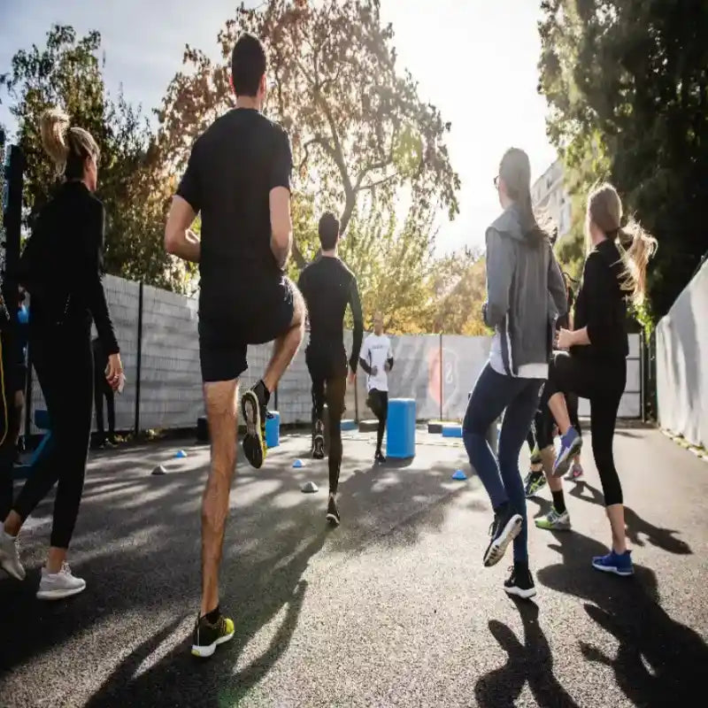 Group outdoor fitness training session - athletic wear and running gear