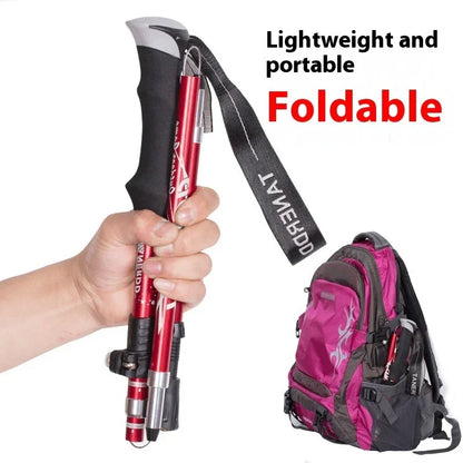 Hand holding a foldable hiking trekking pole, backpack shown, lightweight outdoor gear