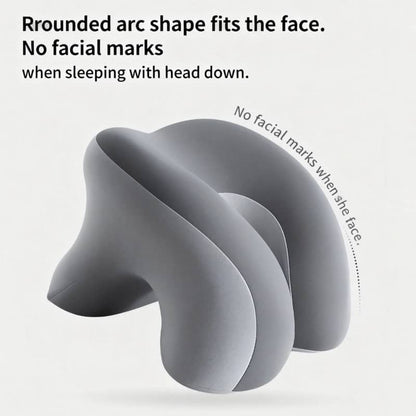 Gray neck pillow with rounded arc shape on a light gray background
