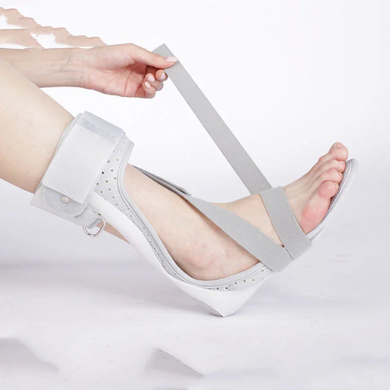 White sandal with transparent straps being worn on a white background