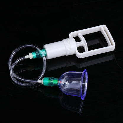 Cupping therapy device with a glass cup on a black background