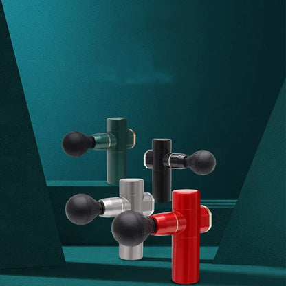 Four compact handheld massage guns in red, black, silver, and green on green geometric background for muscle recovery