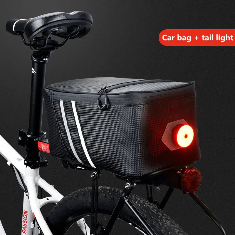 Black bike trunk bag with reflective stripes and integrated rear LED tail light mounted on a bicycle rack