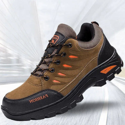 Brown and black outdoor hiking shoe with rugged sole, mesh panels, and orange accents.