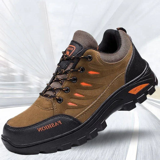 Brown and black outdoor hiking shoe with rugged sole, mesh panels, and orange accents.
