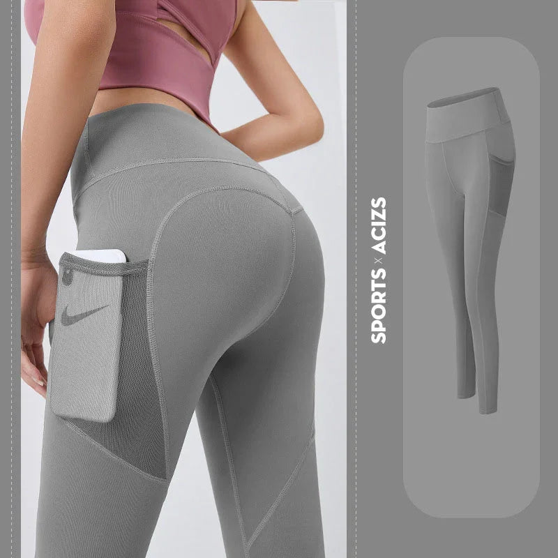 Gray leggings with a pocket and Nike logo, worn by a person, on a light gray background.