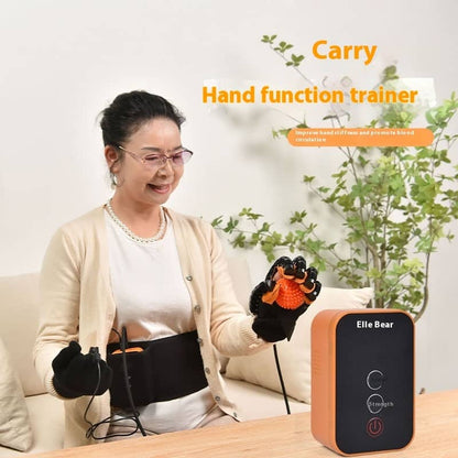 Woman using a hand function trainer with 'Elle Bear' device on a table, indoor setting.