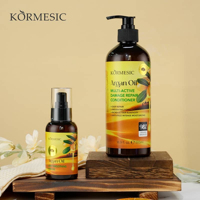 Kormesic Argan Oil hair care products on a wooden stand with a beige background