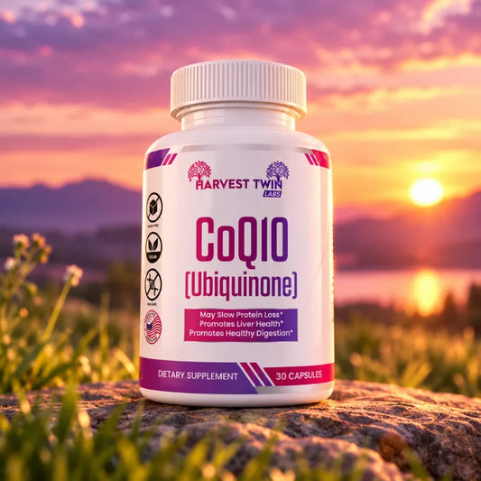 A bottle of Harvest Twin CoQ10 dietary supplement stands on a rock outdoors at sunset, with grass, water, and a glowing sun in the sky behind it.