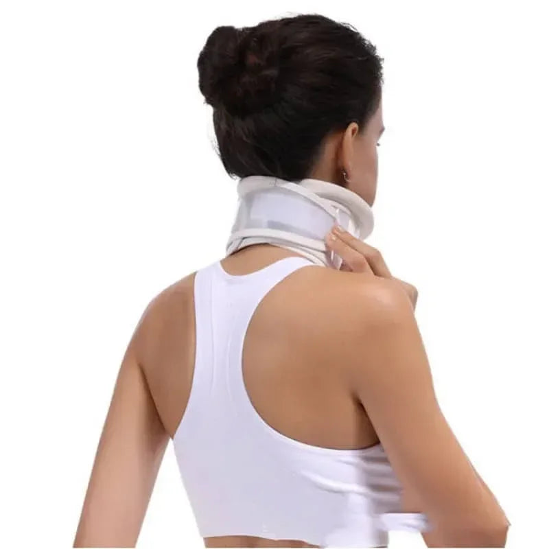 Woman wearing a white neck brace on a white background