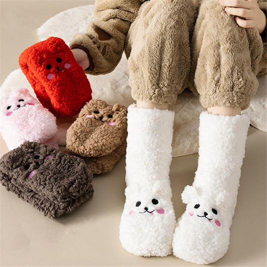 Plush animal face slippers in various colors on person wearing cozy loungewear.
