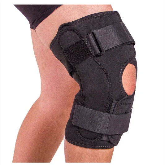 Adjustable black knee brace with straps on a person’s leg for fitness and joint support