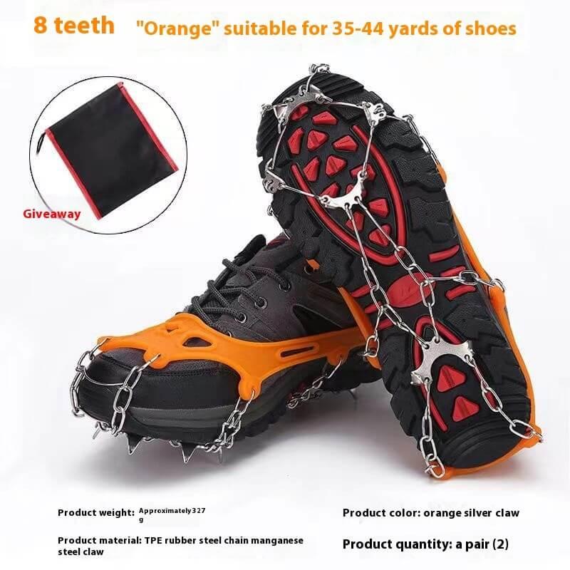 Black hiking shoes with orange ice cleats and steel spikes, traction gear for outdoor fitness.