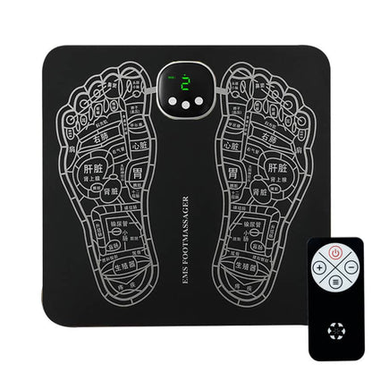 Black foot massage mat with acupressure design and remote control on a white background