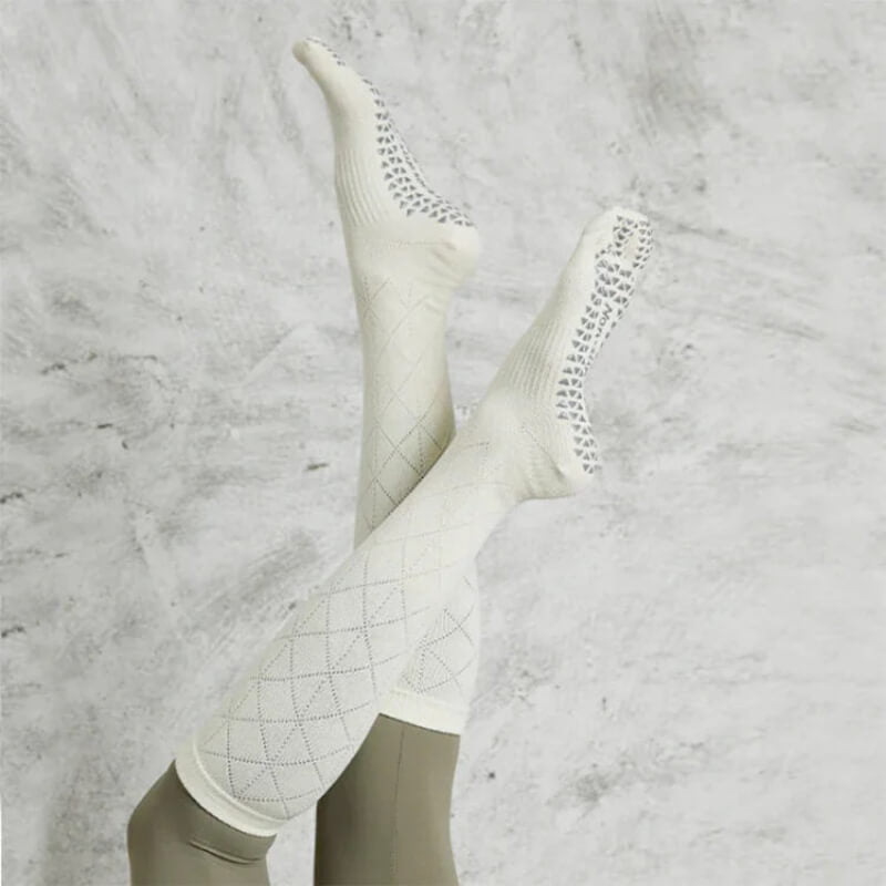 White knee-high grip socks with diamond pattern, ideal for yoga or pilates workouts