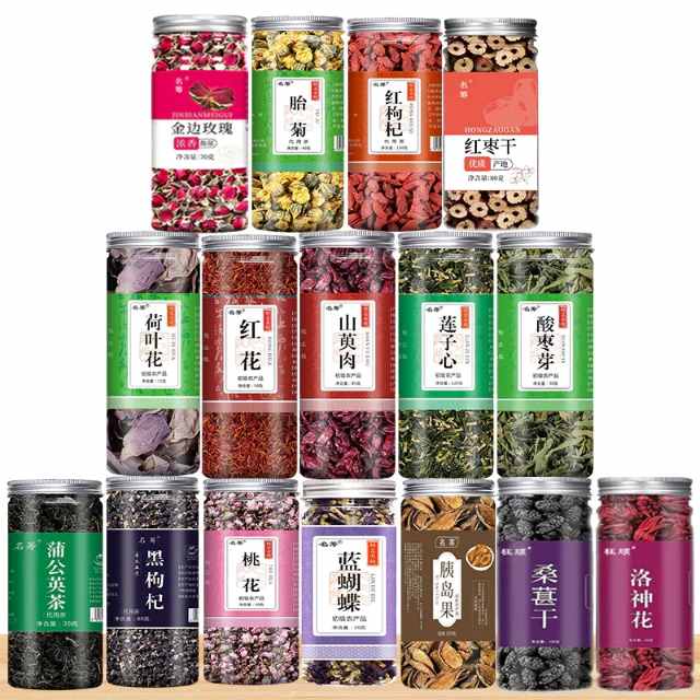 Assorted herbal tea leaves and dried fruit in clear jars, displayed in rows