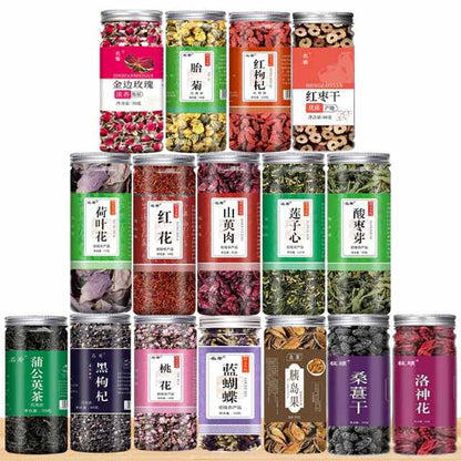 Assorted herbal tea leaves and dried fruit in clear jars, displayed in rows