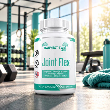 A white bottle of Harvest Twin Labs Joint Flex dietary supplement capsules, set on a gym floor with dumbbells, a towel, and a window in the blurred background.